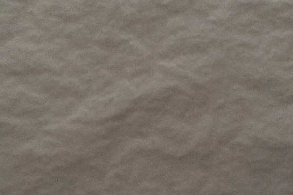crumpled cream craft paper background texture. closeup