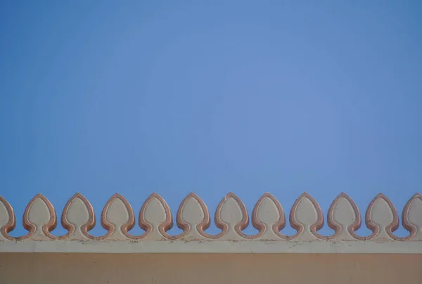 Arabic pattern on the roof of the building on the background blue sky