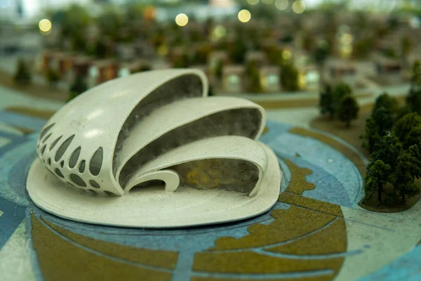 a miniature model of a city building in the form of a shell.