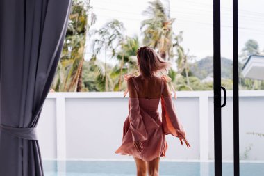 Genç, güzel, beyaz tenli, romantik bir kadın. Yazlık, şirin bir elbiseyle tatilde.