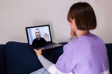 Woman at home face time video call her friends husband boyfriend, chatting online from laptop