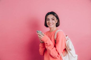 Akıllı telefonu olan genç ve güzel bir kadın. Gülümseyen öğrenci kız seyahate çıkıyor..