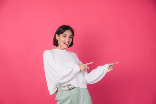 Woman Casual White Sweater Pink Red Background Smile Point Right — Stock Photo, Image