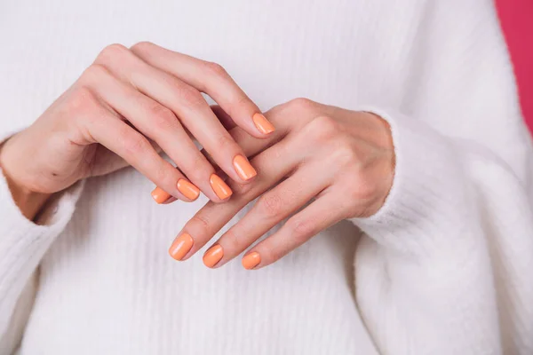 Quadro Fechado Das Mãos Mulher Com Manicure Laranja Suéter Branco — Fotografia de Stock