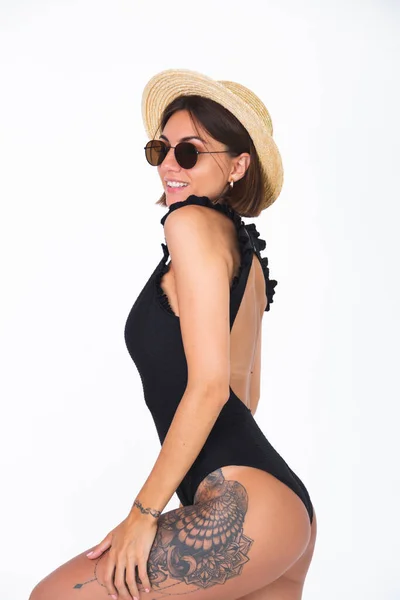 身穿黑色泳衣 戴着黑色太阳镜 头戴草帽 头戴白色底座 垂直边框的晒黑妇女 — 图库照片