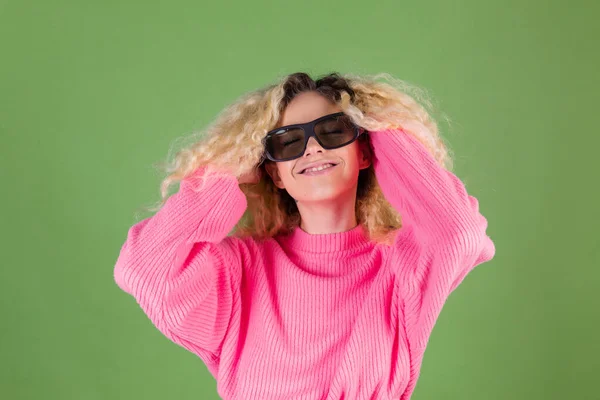 Mladá Blondýna Žena Dlouhými Kudrnatými Vlasy Růžovém Svetru Zeleném Pozadí — Stock fotografie