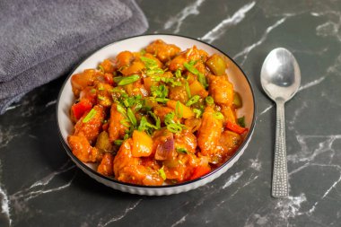  Crispy baby corn tossed in tangy, spicy Indo-Chinese Manchurian sauce, garnished with spring onions, bursting with flavour and crunch.