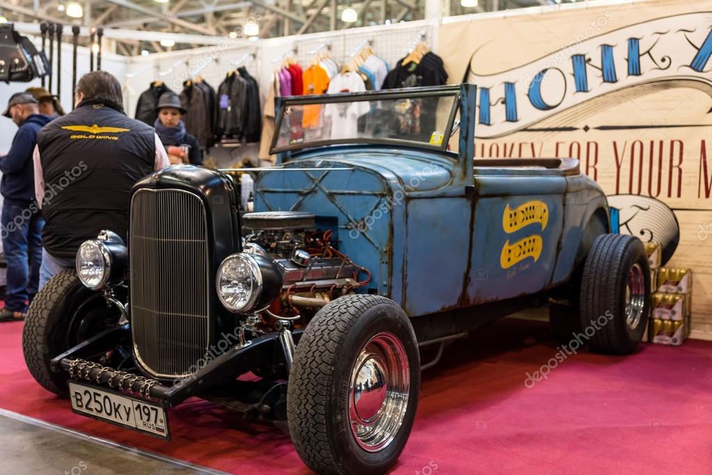 Winter 2015. Morning. Russia. Moscow. Crocus-Expo. Exhibition Motopark-2015 (BikePark-2015). The exhibition stand of the Honky Tonk bar. The Retro car with logo of the Bar on the door.