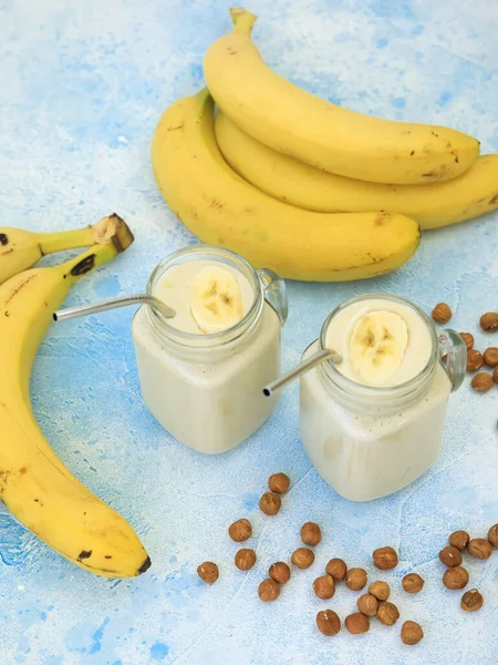 Trasty yogurt with banana and nuts, vegetarian food, diet and health concept
