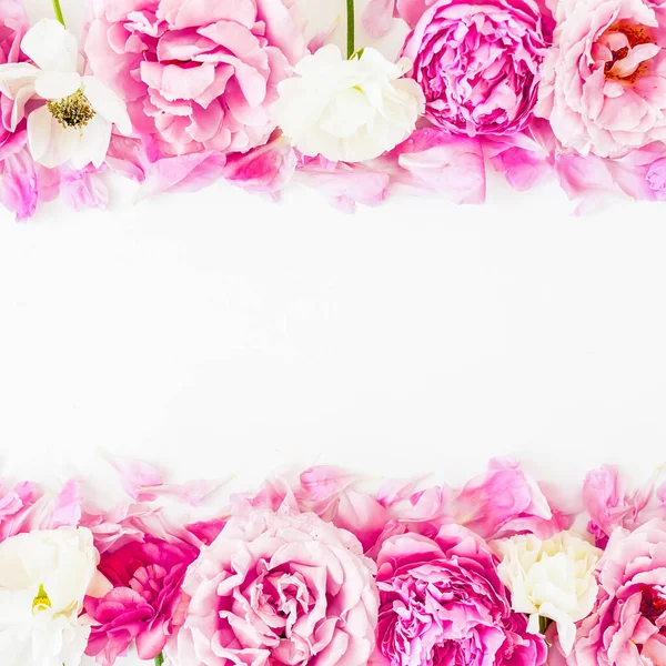 Floral frame of pink roses, peonies and anemones on white background. Flat lay, Top view