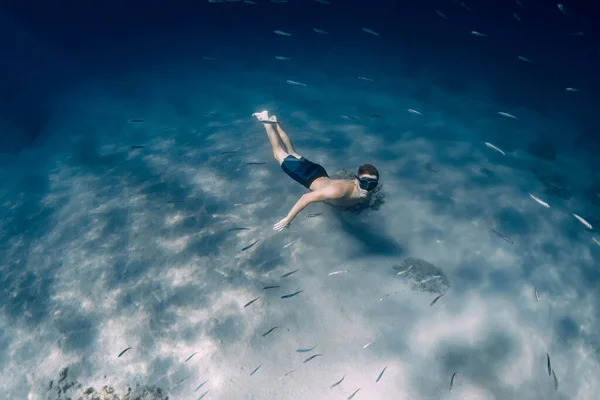 男性フリーダイバーは青い海で水中フィンなしで滑空 — ストック写真