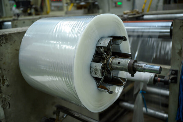 Polypropylene (pp.) film production machinery is working in a plastic bag factory.