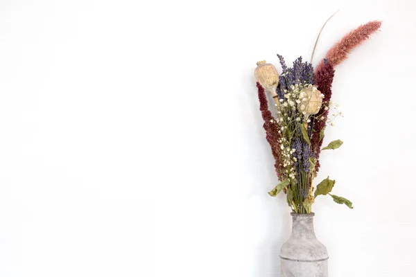 Gray concrete vase with bright dried bouquet flowers in front of the white wall modern decoration of home, copy space — Stock Photo, Image