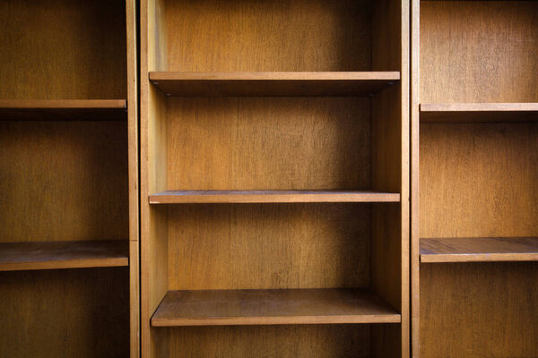 Empty wooden book shelf with or storage rack modern retro design, copy space background texture