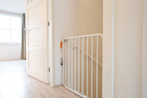 Protective white baby safety stair gate in hallway stairwell modern new house, fence for children in beautiful home — Stock Photo, Image