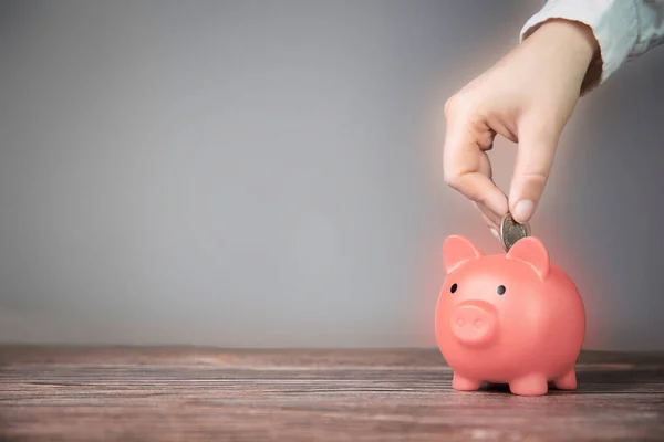 Human Hand Putting Coin Pink Piggy Bank Blurred Background Saving — стокове фото