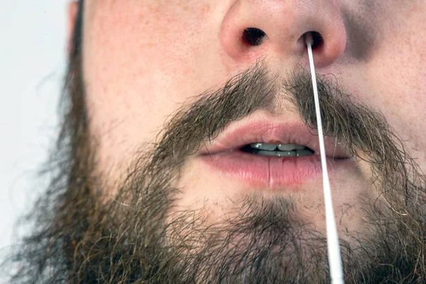 Covid-19 nasal swab test, taking nasal mucus test sample, Cotton swab from the throat and nose close-up macro portrait, Health, coronavirus,testing,business concept medical