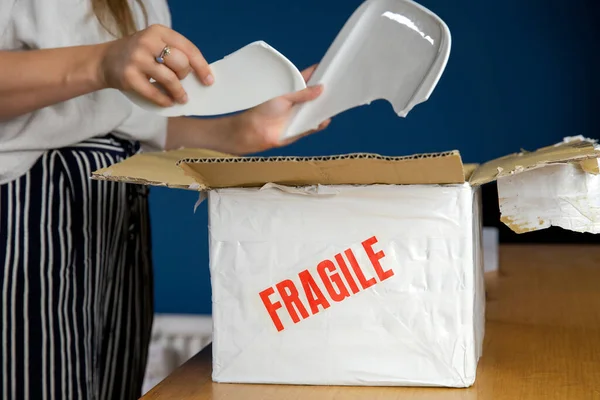Young Woman Opening Damaged Delivery Package Online Shopping Package Broken Royalty Free Stock Images