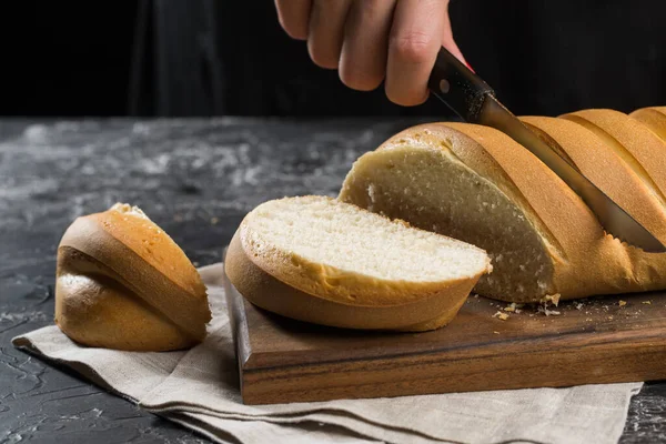 Cutting bread on a black background