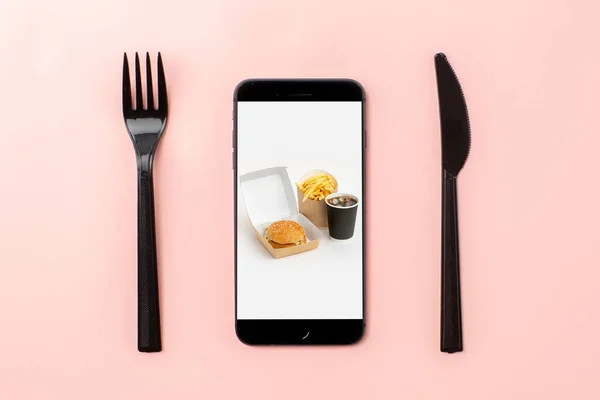Online food delivery concept, phone and cutlery