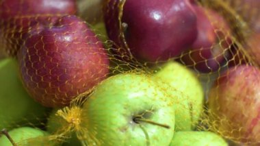 Juicy red and green apples in a grid. Fresh fruits on a white table.