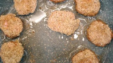 Close up video of cooking  homemade meatballs, cutlets, nuggets, kebab on a non-stick pan in oil. Crispy fried pattys. Traditional home cooking.  Homemade recipe for cooking meat dishe.