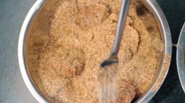 Close-up of meat ball pull into a breadcrumbs for frying in a pan for cooking delicios nice yammy food.