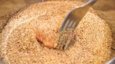 Close-up of meat ball pull into a breadcrumbs for frying in a pan for cooking delicios nice yammy food.