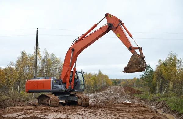 Orange grävmaskin Royaltyfria Stockbilder