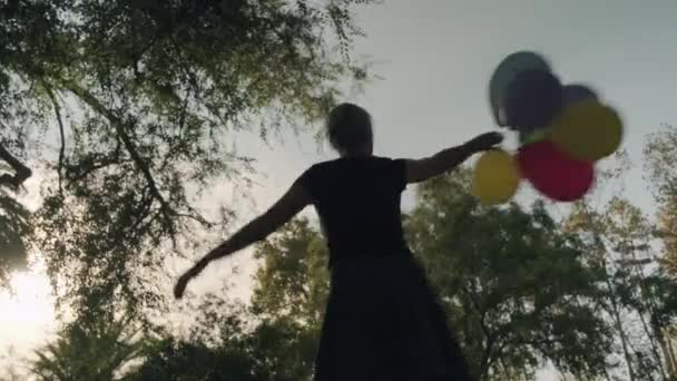 Giovane ragazza con palloncini colorati nelle sue mani — Video Stock