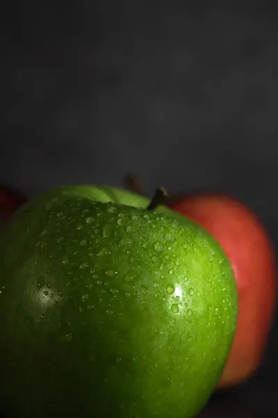 Green and red apple on dark background — Stock Photo, Image