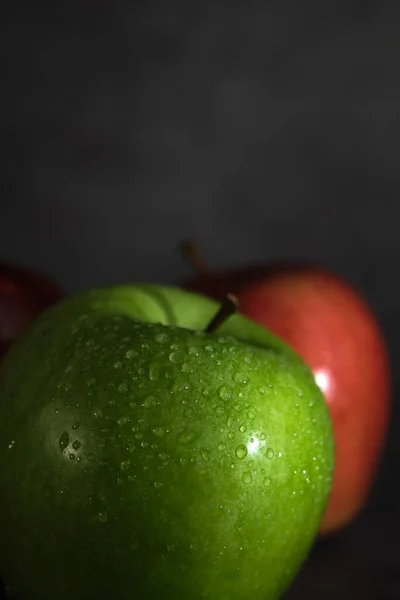 Green and red apple on dark background — Stock Photo, Image