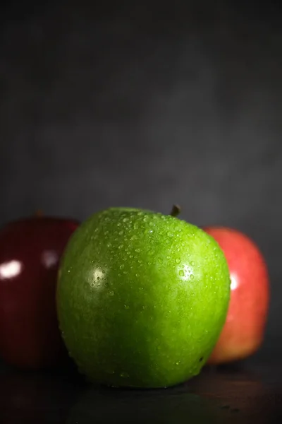 Green and red apple on dark background — Stock Photo, Image