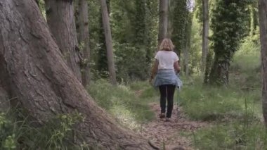 Bir kız ormanda yürüyor.