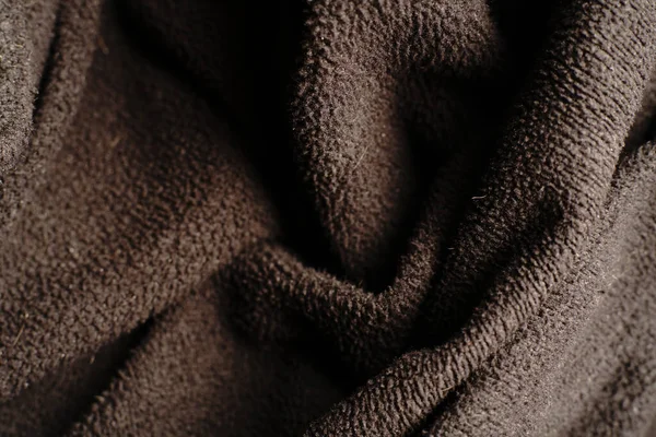 Dalgalar halinde giden tekstil siyah dokusu. Loş ışıklar.