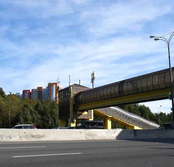 Pedestrian crosswalk raised above the expressway. A building for a safe crossing of the highway