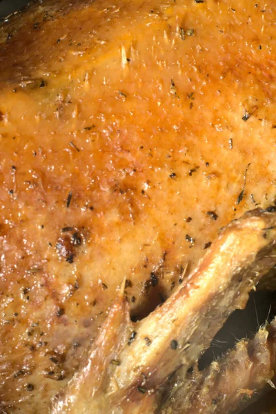 Duck cooked at home golden color. Closeup. You can see the wing and the vertical shot