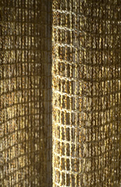 Elegant texture of the mesh woven from textiles. It comes in waves. Vertical snapshot — Stock Photo, Image