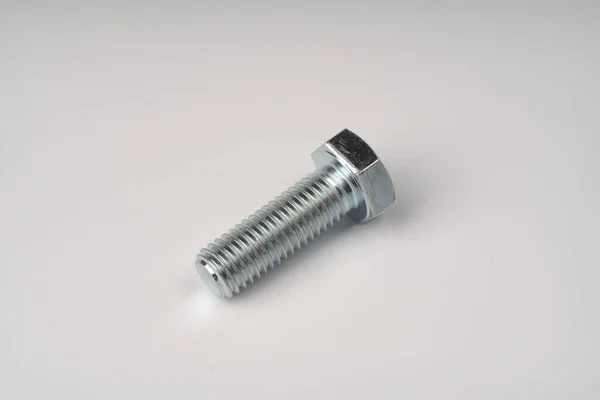 Metal large bolt with thread on white background. Fotos de stock