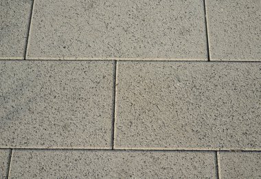 The texture of the tile in the form of rectangles of light gray color
