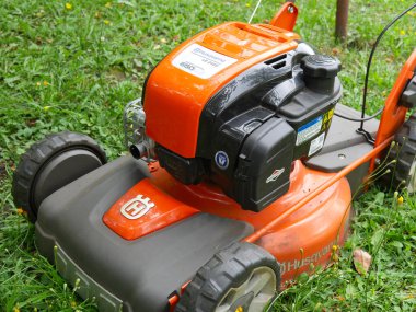 Moskova, Rusya - 20 Haziran 2020: Turuncu markalı çim biçme makinesi yazın yeşil çimlerin üzerinde duruyor