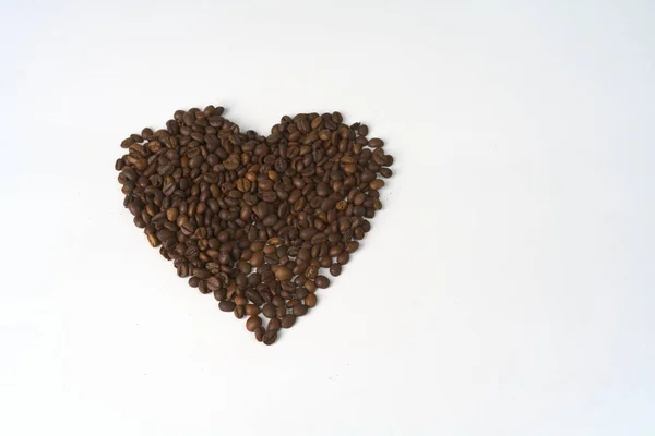 Un grande cuore fatto di chicchi di caffè su sfondo bianco. — Foto Stock