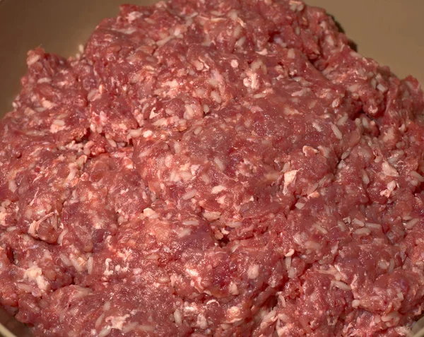 Red meat passed through a meat grinder in a large plastic bowl. — Stock Photo, Image