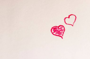 Renkli boya kalemleriyle şekillenen kalp çizimleri kağıt üzerinde.