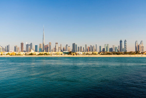 Dubai, UAE - 02.27.2021 Dubai public beach with city skyline on background.