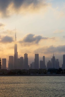 Dubai, BAE - 03.06.2021 Dubai halk plajı. Arkaplanda şehir silüeti var. Gün doğumu saati.