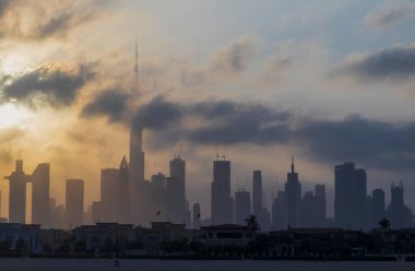 Dubai, BAE - 03.06.2021 Dubai halk plajı. Arkaplanda şehir silüeti var. Gün doğumu saati.