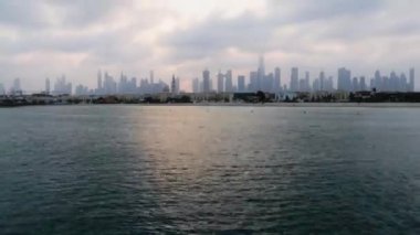 Dubai, BAE - 03.06.2021 Dubai halk plajının arka planda silueti olan zaman atlaması. Gün doğumu saati. Açık havada.