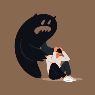 Korku ya da panik atak. Başını eğmiş üzgün bir adam kendi gölgesinden bile korkar. Depresyon, yalnızlık, endişe konsepti.