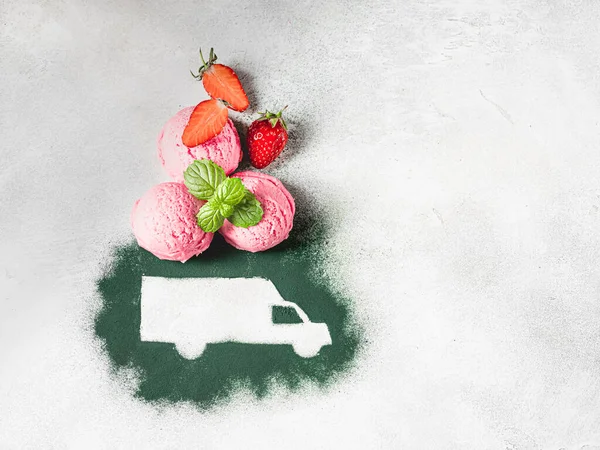 Car made of green powder and balls of berry ice cream on a light background. Online shopping. Concept of delivery services, logistics, cargo delivery. Food delivery. Copy space